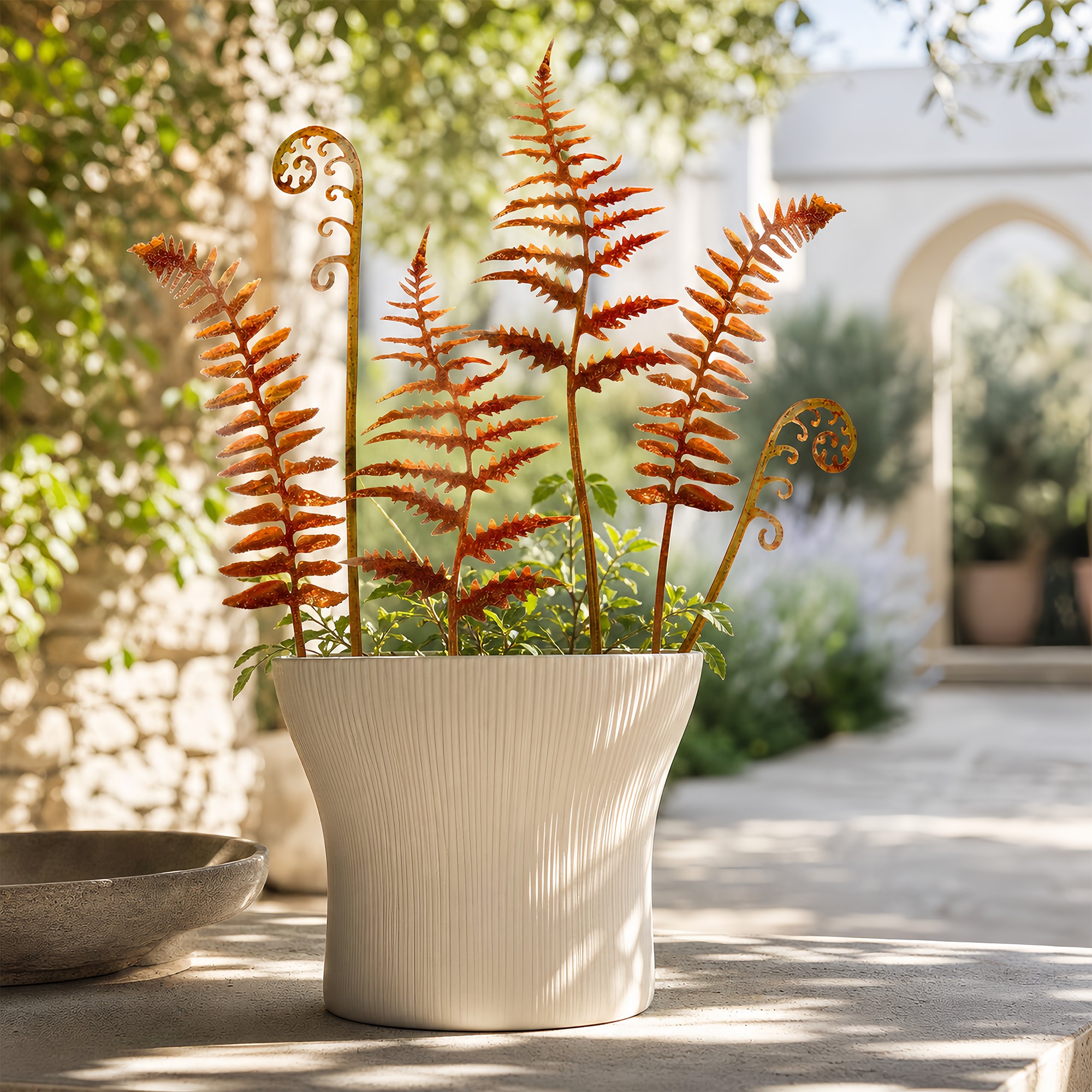 Metal fern stakes displayed in flower beds and planters