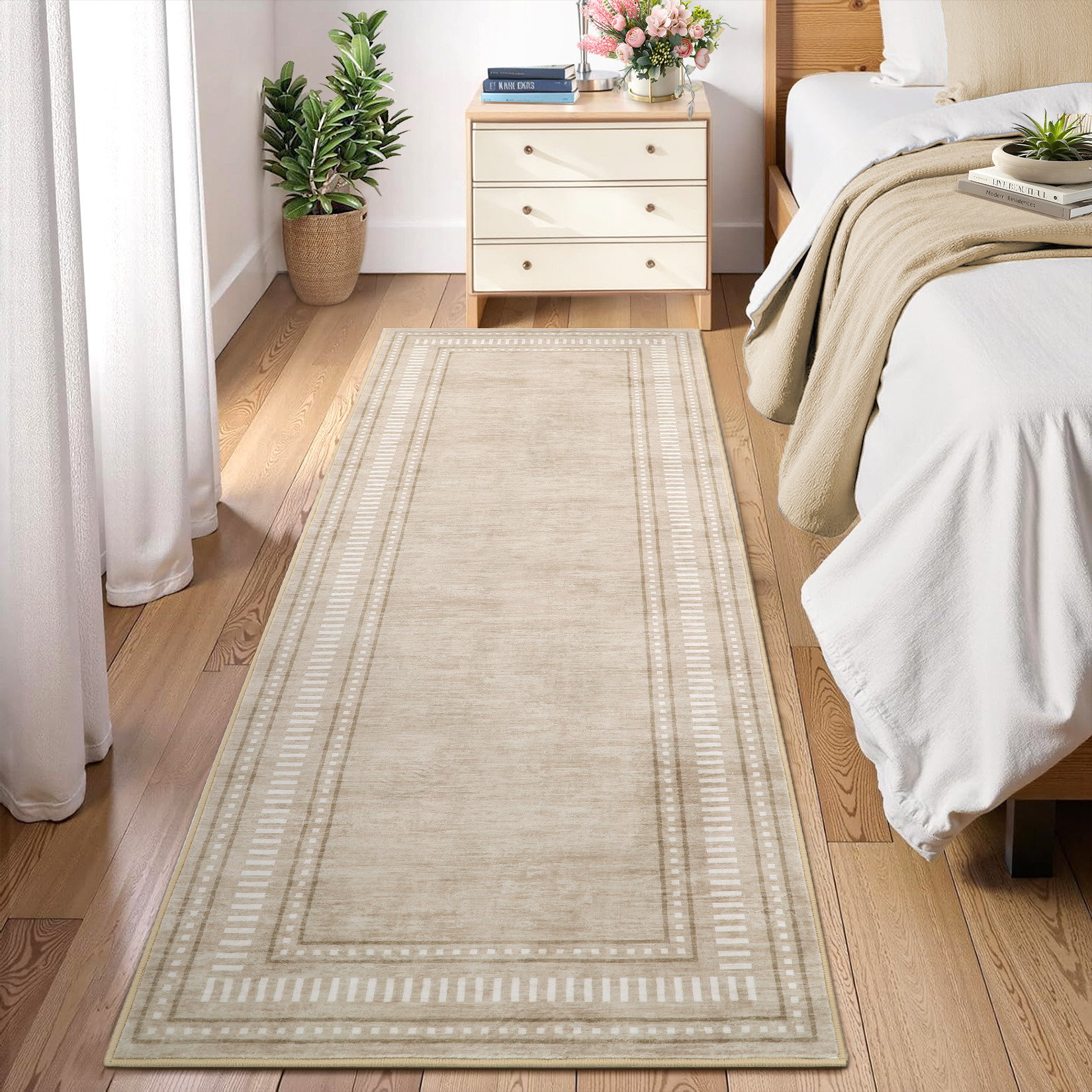 Washable beige area rug placed beside a bed for a soft, low-profile step in the bedroom